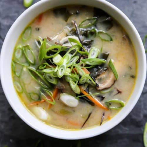 Homemade miso soup in a white bowl with vegetables