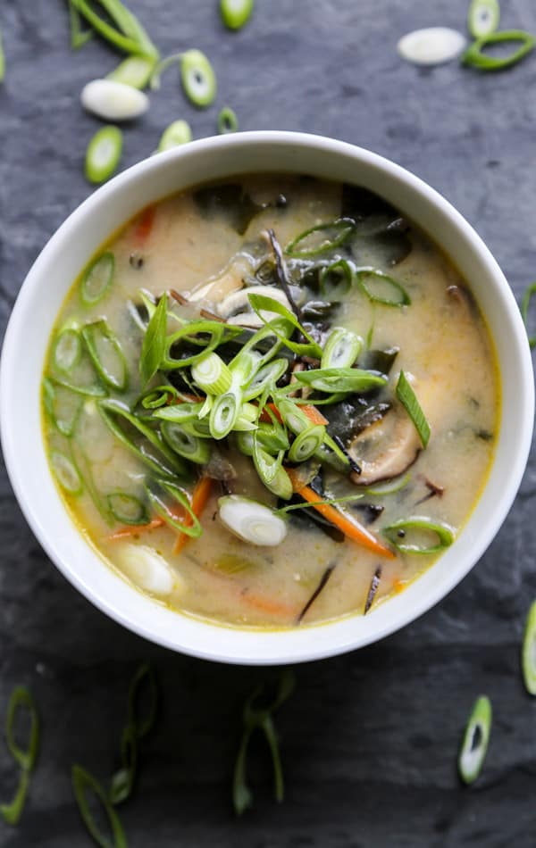 photo of miso soup in a white bowl with scallions on top