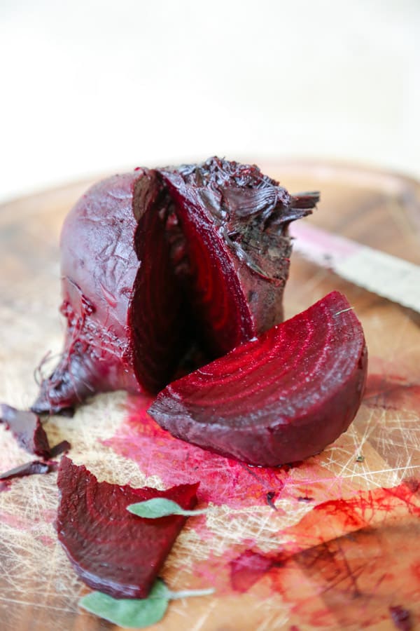 roasted beet sliced on a cutting board