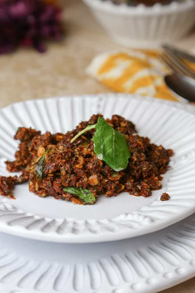sun dried tomato tapenade with almonds and mint on a plate 