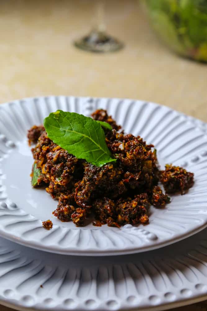 sun dried tomato tapenade with almonds and mint on a plate 
