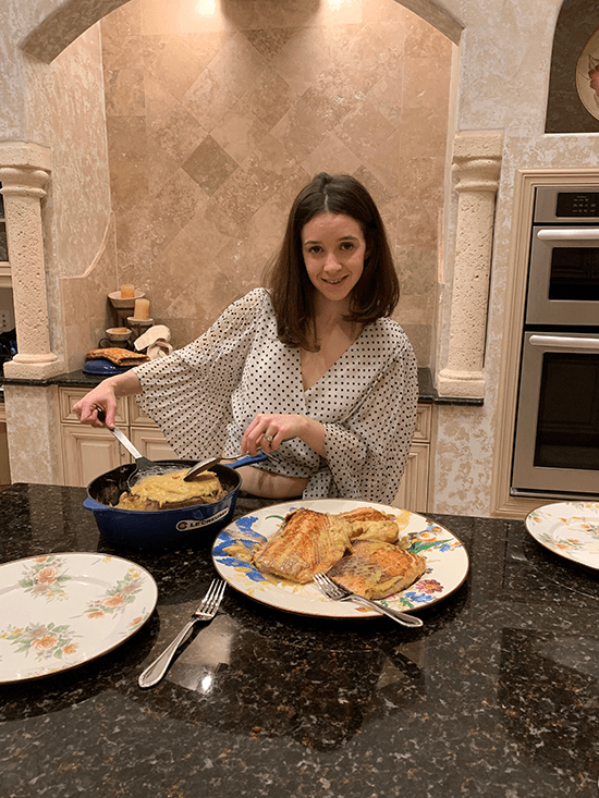 girl serving salmon on a plate