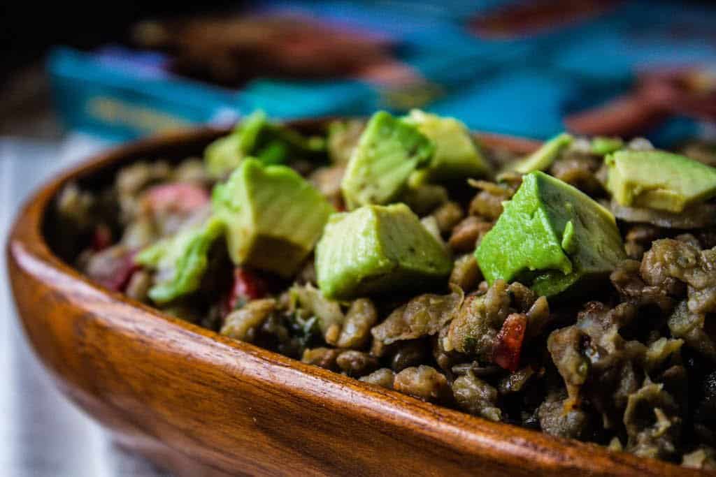 bowl of lentil salad with avocado