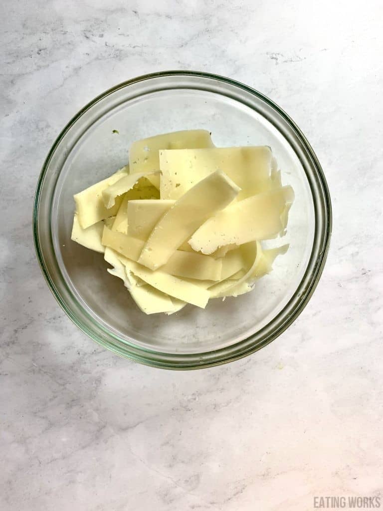 a bowl of shaved manchengo cheese for courgette salad