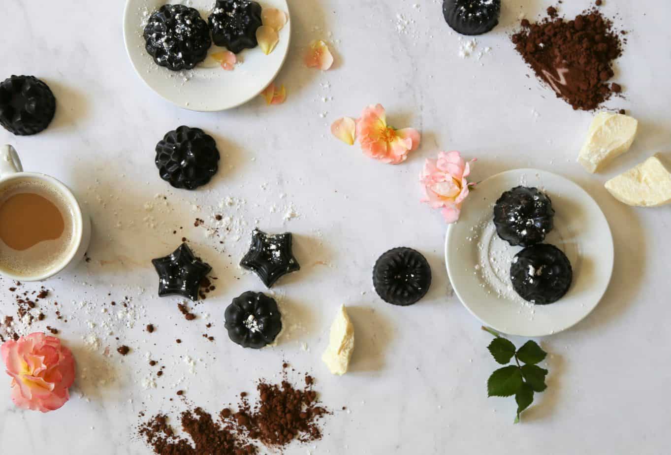 table scape of chocolate bon bons expresso in a white cup and white plates