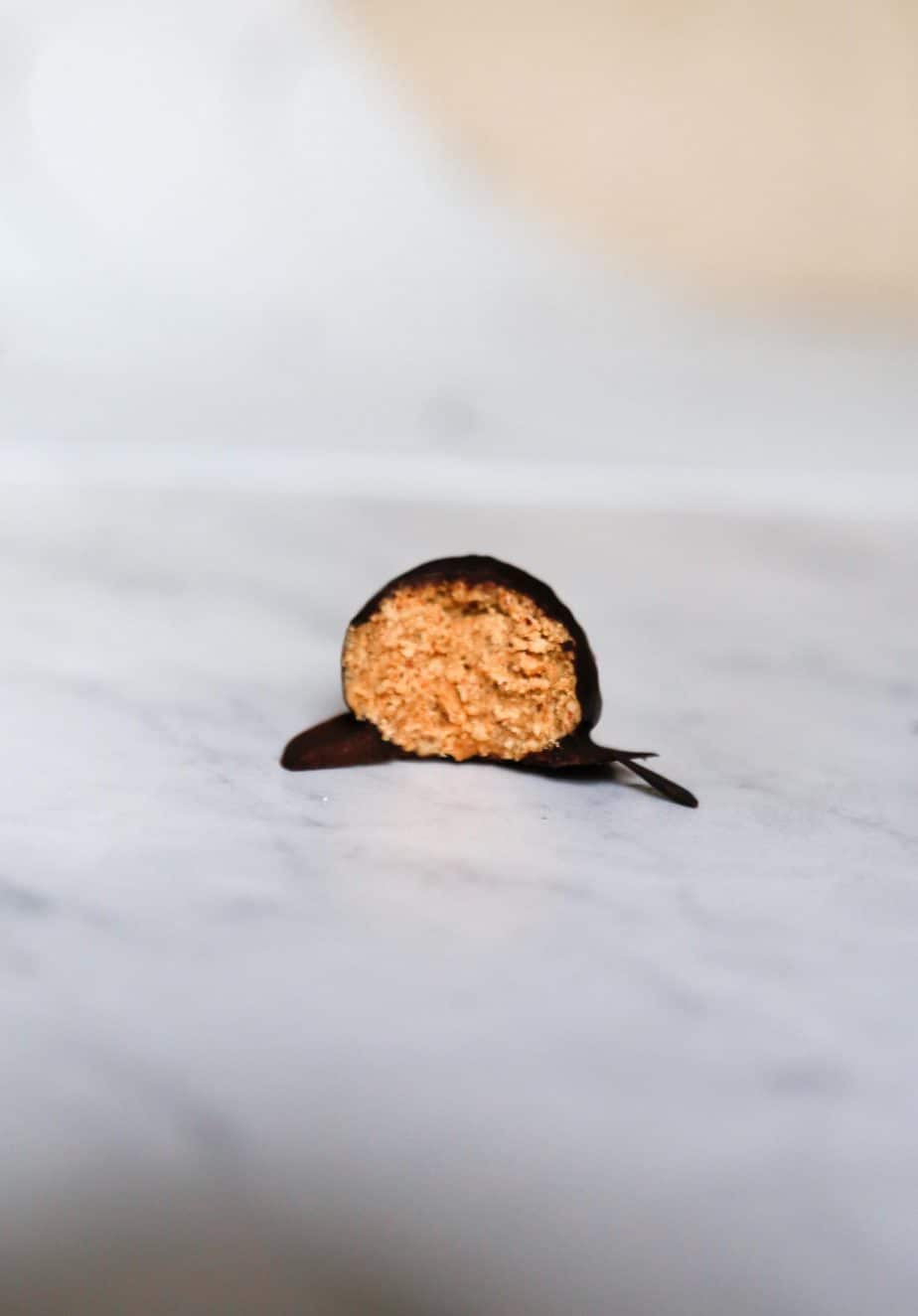 a vegan chocolate truffle bitten in half to show the inside