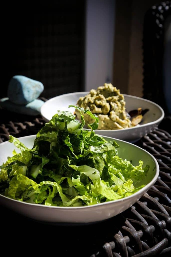 Marouli salad with lettuce dill cucumbers and feta in a white bowl on a table