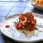 baked eggplant parmesan on a white plate horizontal