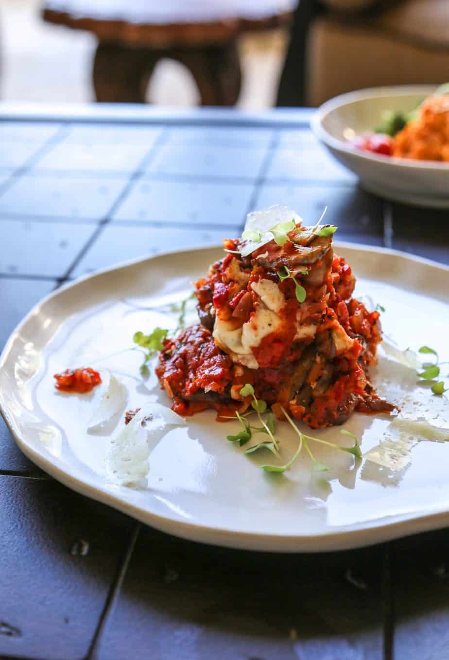 vegan roasted red pepper sauce served in baked eggplant parmesan