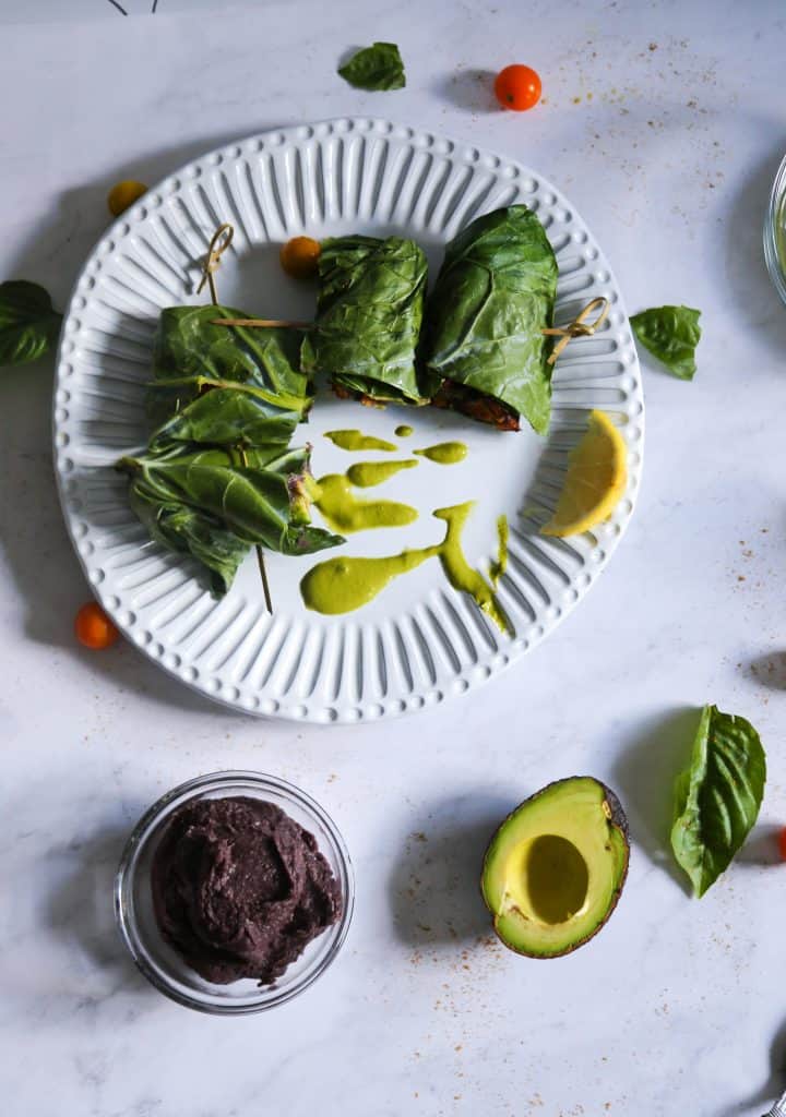 collard green wrap with vegan refried black beans spicy green tahini sauce and cartelized onions and roasted sweet potatoes