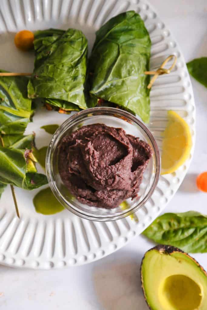 vegan refried black beans made with onions, cumin, canned black beans and lemon juice in a bowl from above.