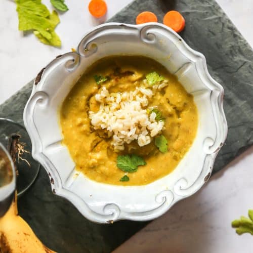 vegan split pea soup in a bowl with banana carrots and parsley