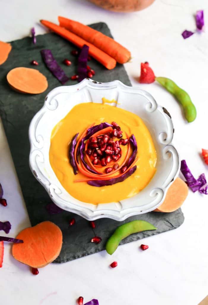 Carrot ginger soup with sweet potatoes in a bowl