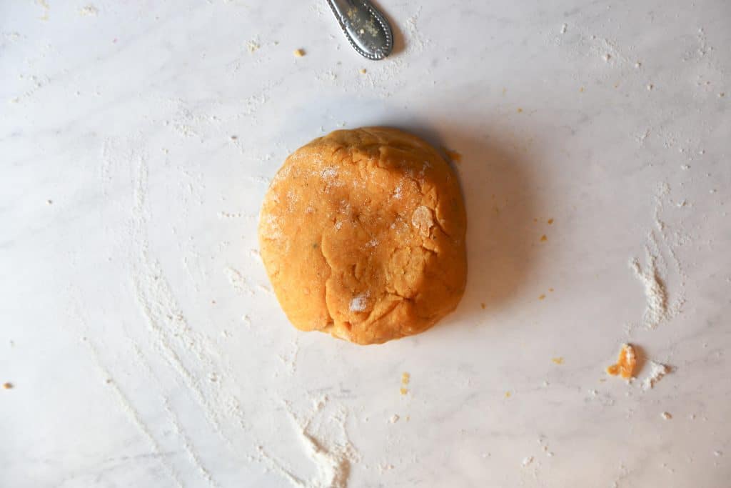 to make smooth vegan sweet potato gnocchi that is also gluten free work the dough until it is smooth.  photo of dough ball on a floured surface