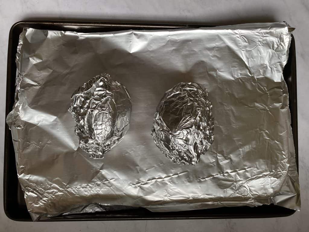 vegan stuffed sweet potato prep photo of sweet potatoes wrapped In foil