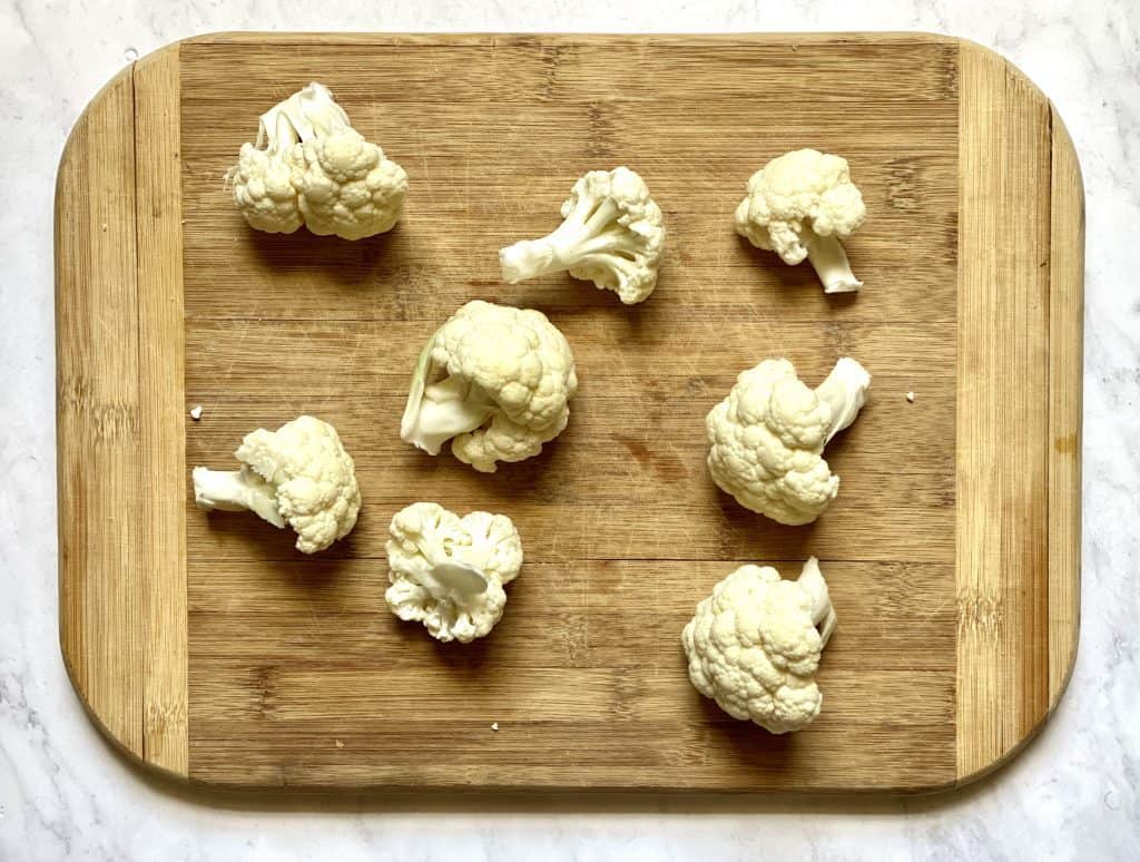 cauliflower florets on a cutting board for keto cauliflower wings 