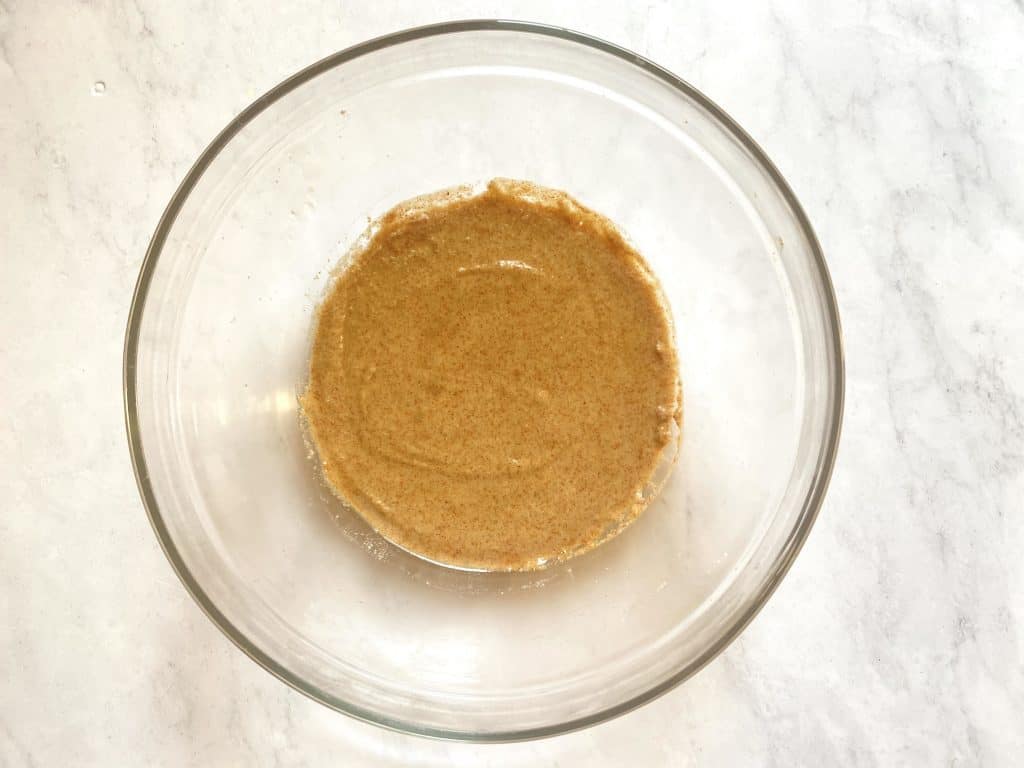 batter in a bowl showing how to create the batter by mixing almond flour, almond milk and spices to