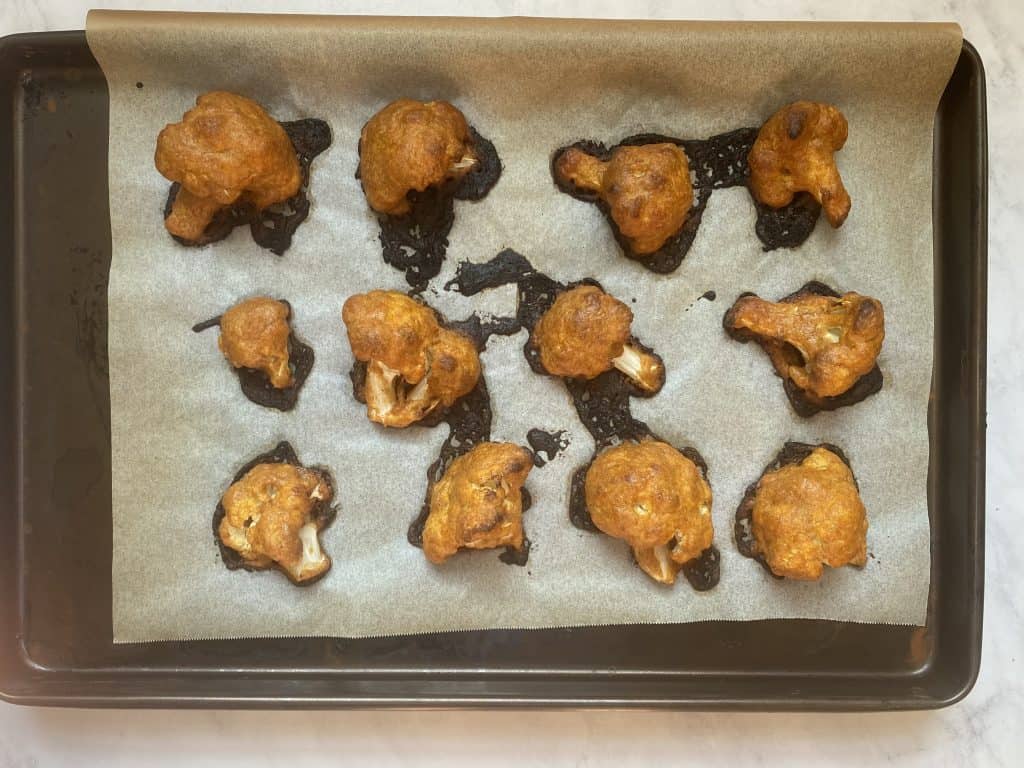 a baking sheet full of cooked keto cauliflower wings 