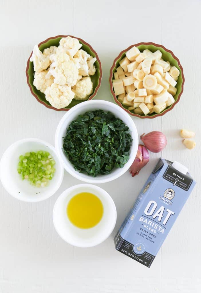 ingredients for parsnip mash. Cauliflower, parsnips, kale, shallots, scallions, garlic, oat milk and olive oil.