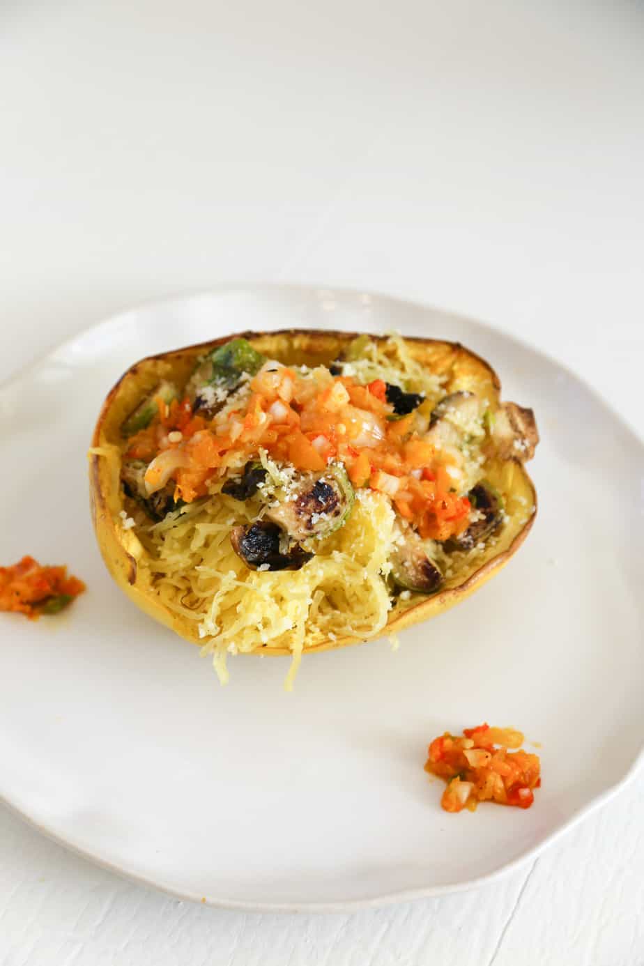 This Vegetarian Stuffed Spaghetti Squash is loaded with veggies and cheese so it tastes like a healthier vegetable pasta. Yet it's low carb, gluten free and YES it can be made vegan. You can enjoy this healthy stuffed spaghetti squash for lunch or dinner if you're on a low carb diet or looking for low carb recipes for a Keto diet."