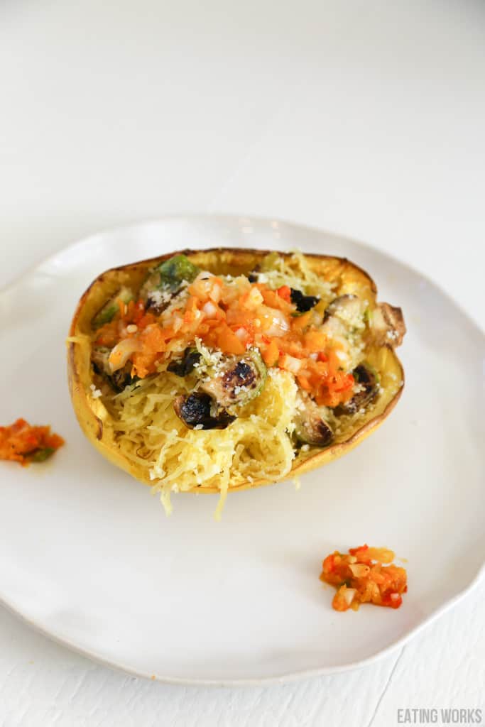 vegetarian stuffed spaghetti squash on a white plate 