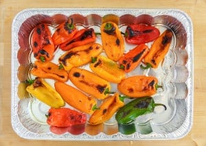photo for step two to cook vegetarian stuffed spaghetti squash peppers on a sheet tray blistered after going into the broiler