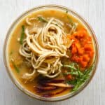 gluten free ramen noodle soup in a bowl with carrots onions and greens