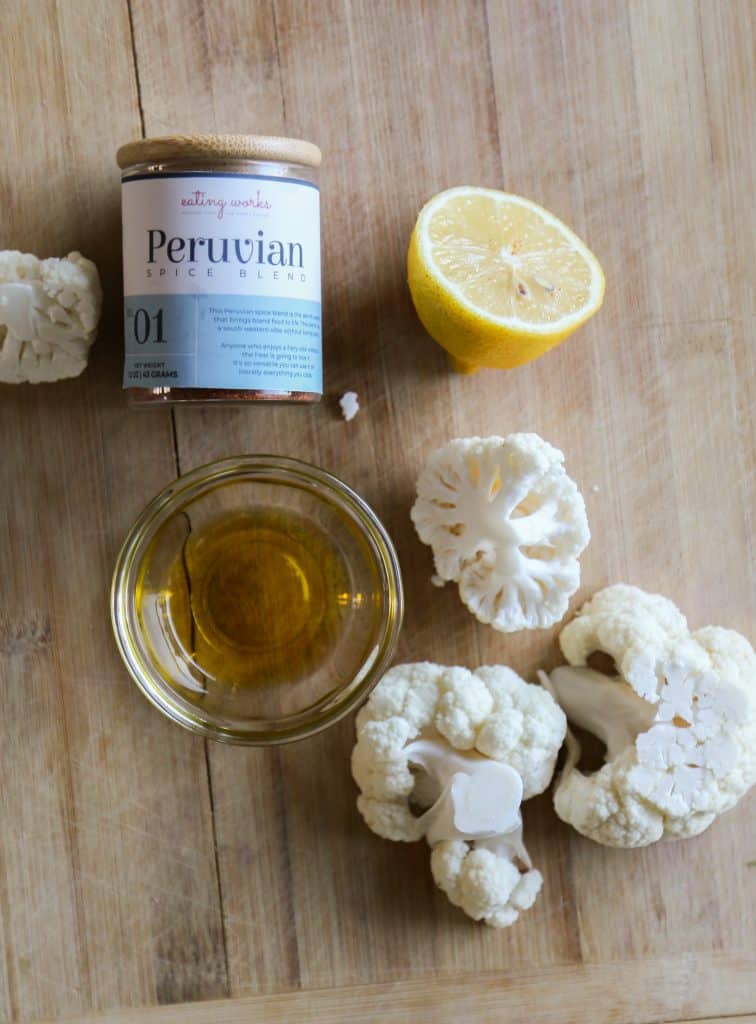 ingredients for air fryer cauliflower steaks, olive oil, cauliflower, lemon and Peruvian spice blend