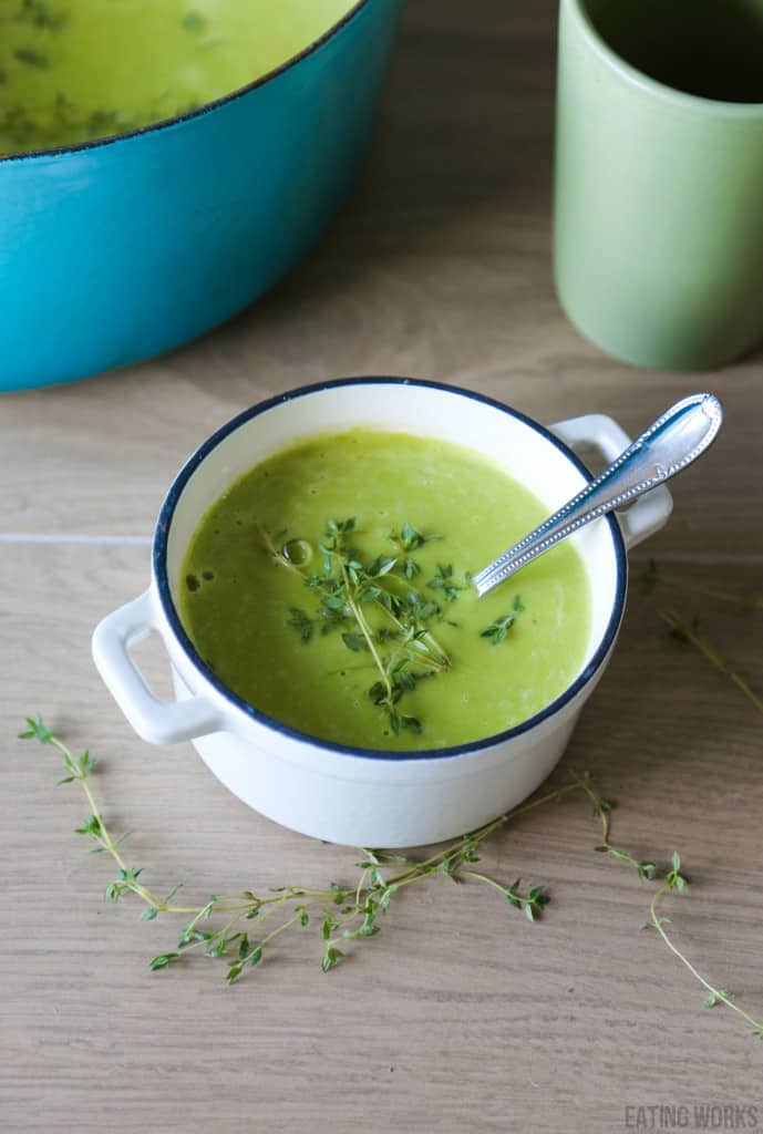 pea soup in a white dutch oven garnished with thyme