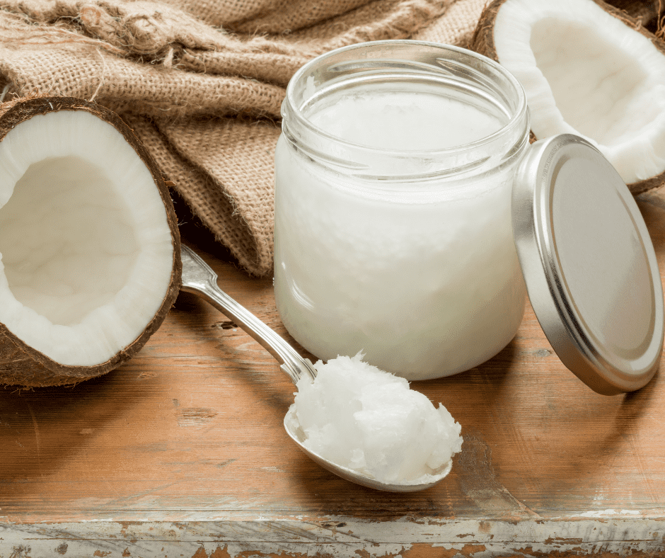 coconut oil in a jar with opened coconuts as a substitute for ghee