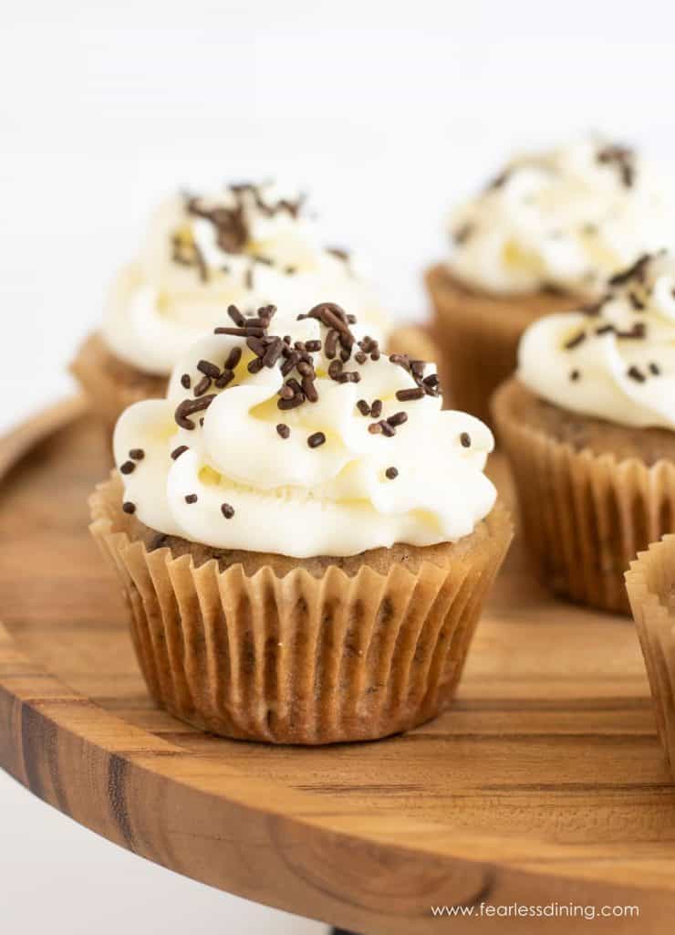 banana cupcakes with chocolate chips on a wooden cutting board