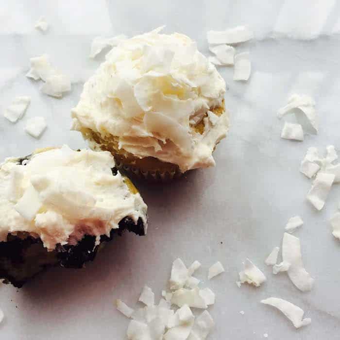 coconut cupcakes with frosting and coconut flakes 