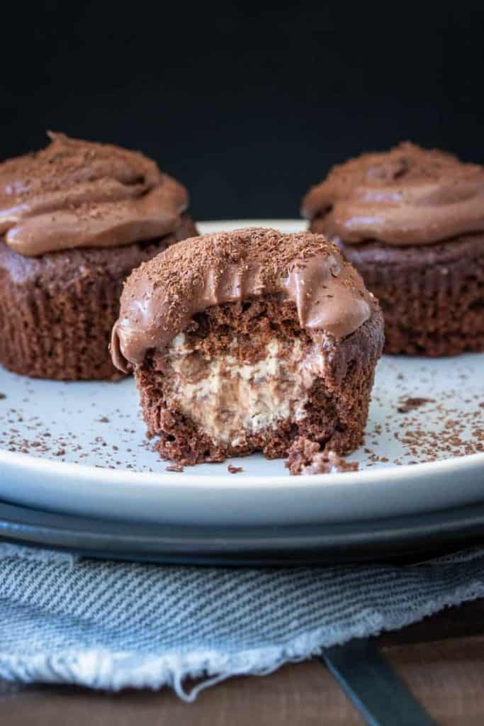 vegan gluten free chocolate ice cream cupcakes on a plate with a bite through the middle 