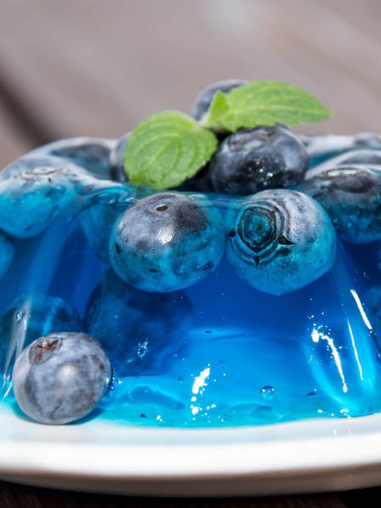 blueberry sugar free jello on a plate with mint leaves