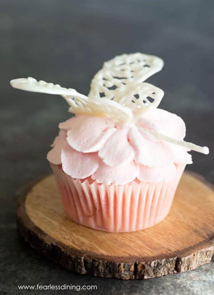gluten free pink lemonade cupcake with a dragonfly on top