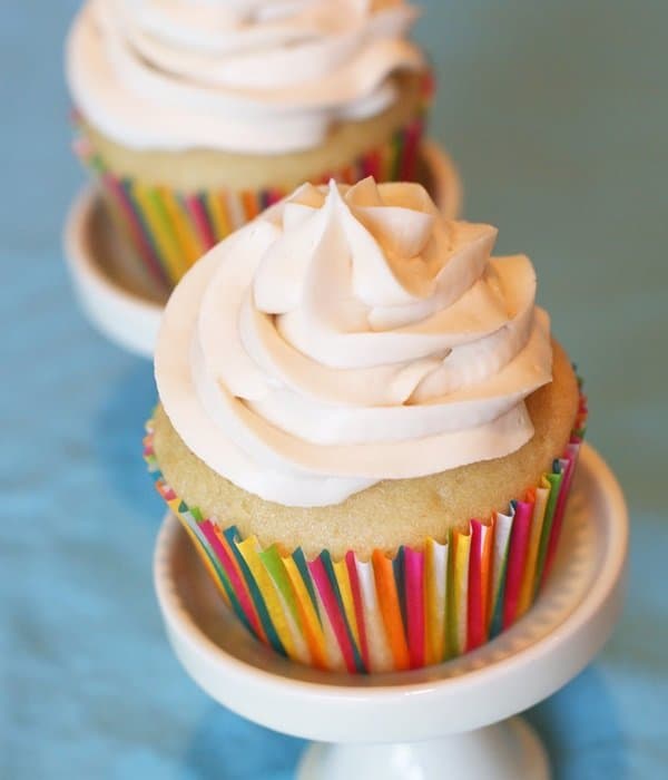 vegan vanilla cupcake with dairy free butter cream frosting with a rainbow foil