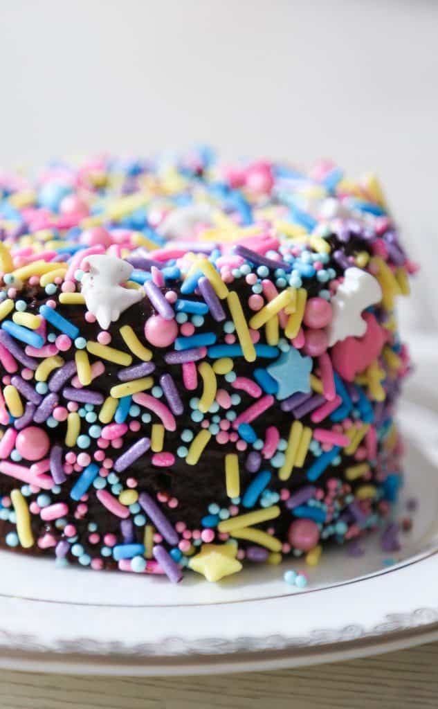 gluten free bento cake covered in sprinkles on a cake plate 