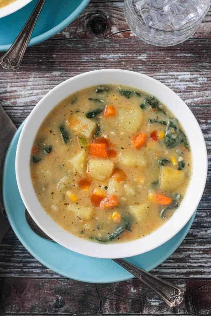 vegan potato soup in a bowl on a blue plate