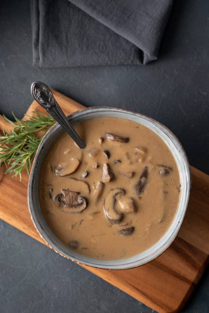 gluten free creamy mushroom soup in a bowl on a cutting board 