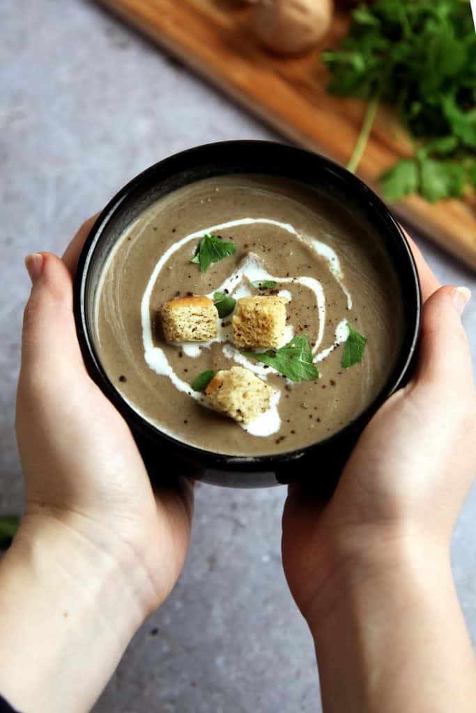 vegan mushroom and chestnut soup in a bowl with croutons 