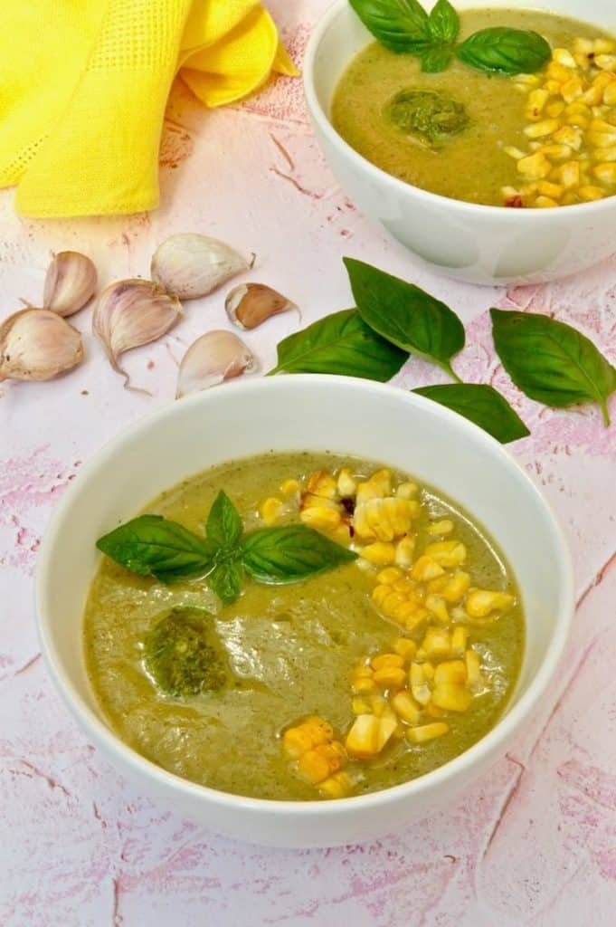courgette soup in a bowl with basil and corn