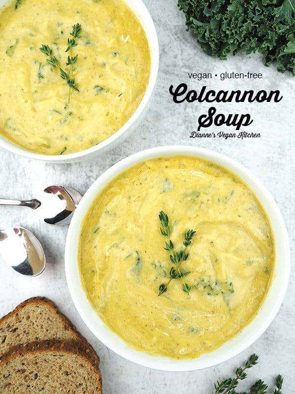 Colcannon soup in two bowls with thyme and bread
