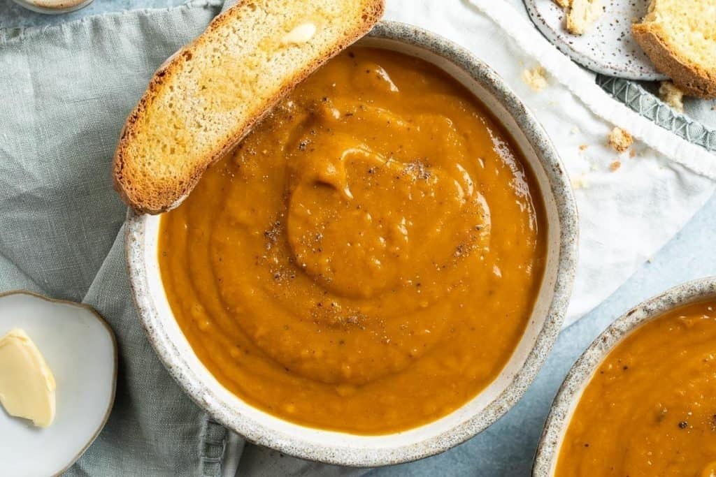 gluten free vegan pumpkin soup in a bowl with toast