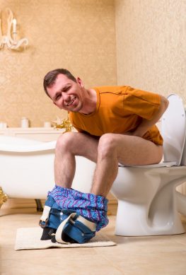 man sitting on toilet with diarrhea