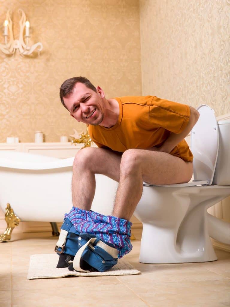 man sitting on toilet with diarrhea