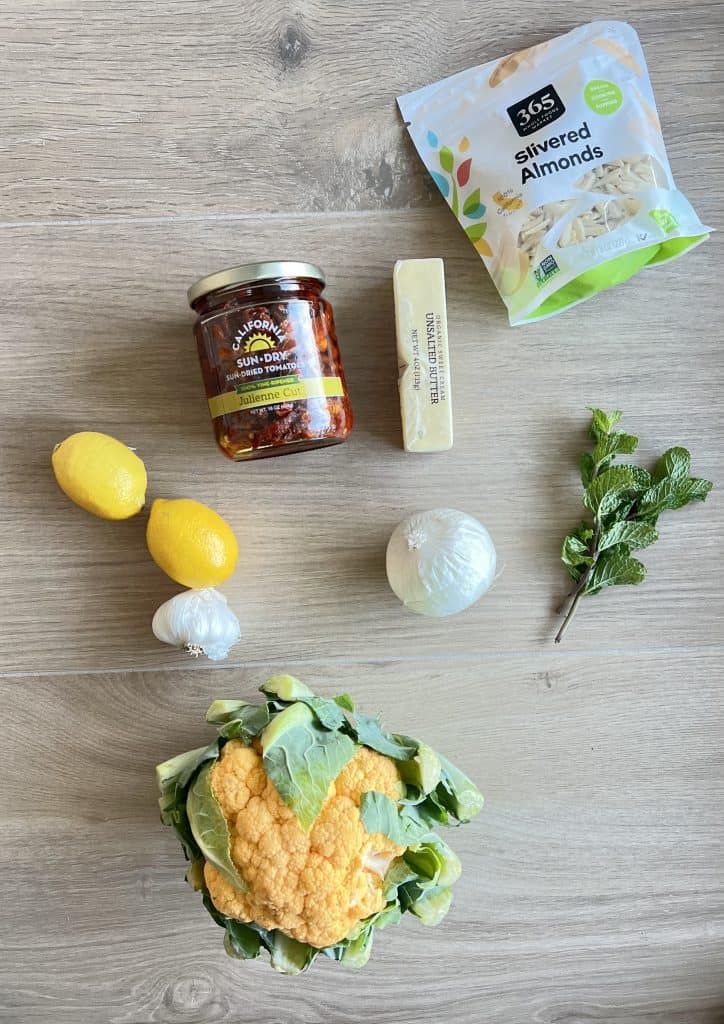 ingredients for keto cauliflower soup, cauliflower, almonds, butter, sundried tomatoes, lemon, garlic, mint.