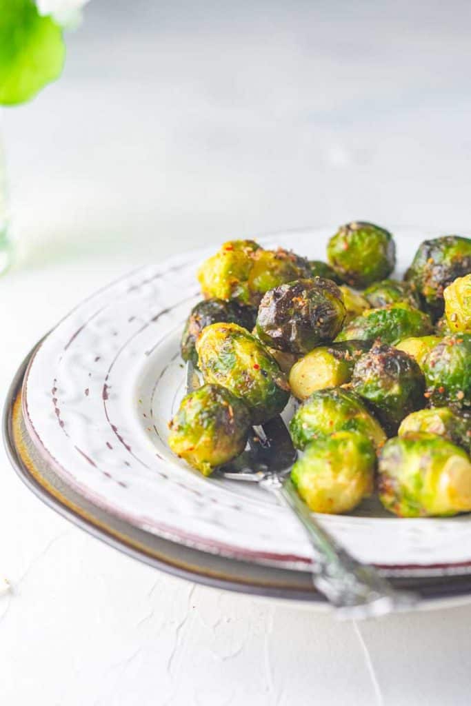 air fryer frozen brussels sprouts on a plate with a fork