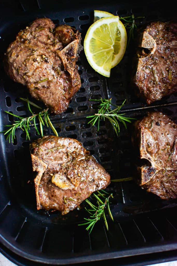 lamb chops cooked in air fryer with rosemary garnish