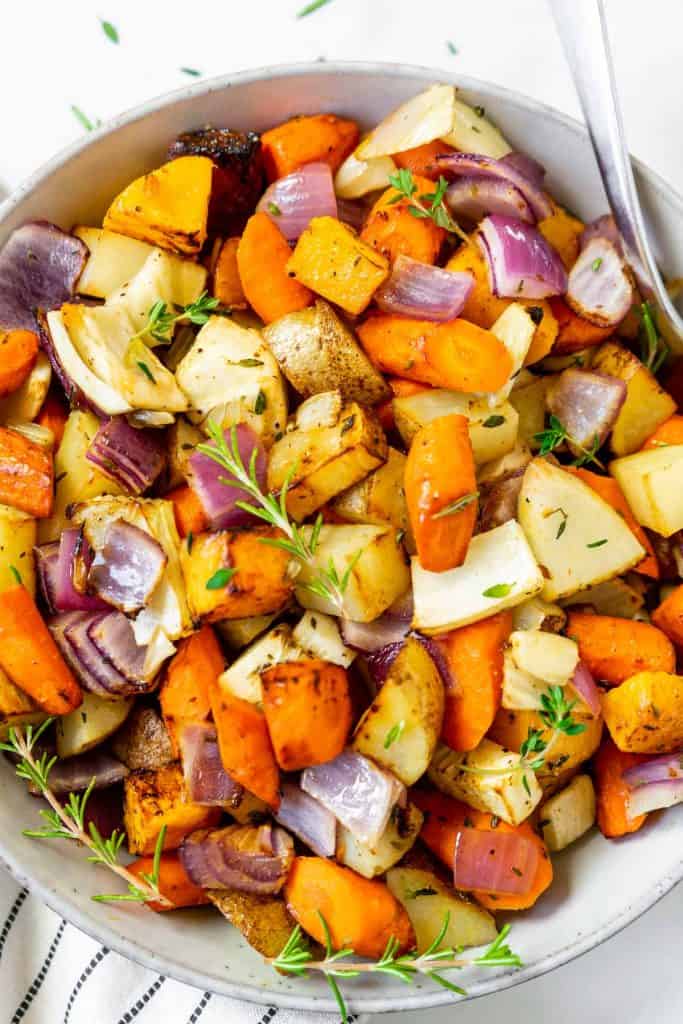 roasted root vegetables on a plate with thyme