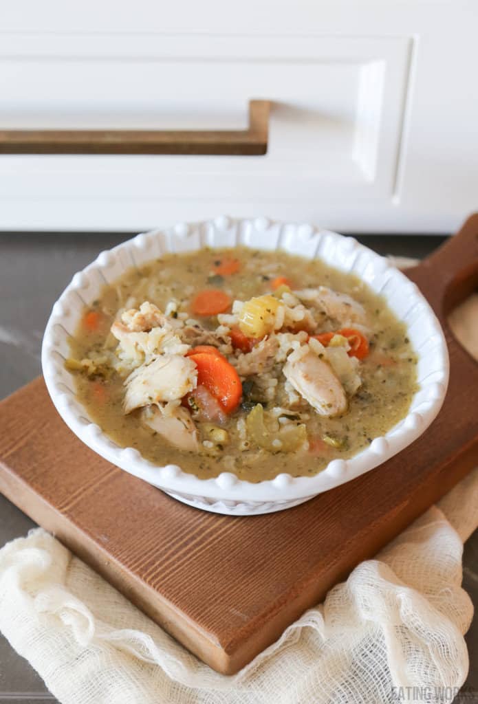 bowl of gluten free chicken soup on a cutting board 